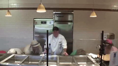 people dancing behind a cafeteria counter