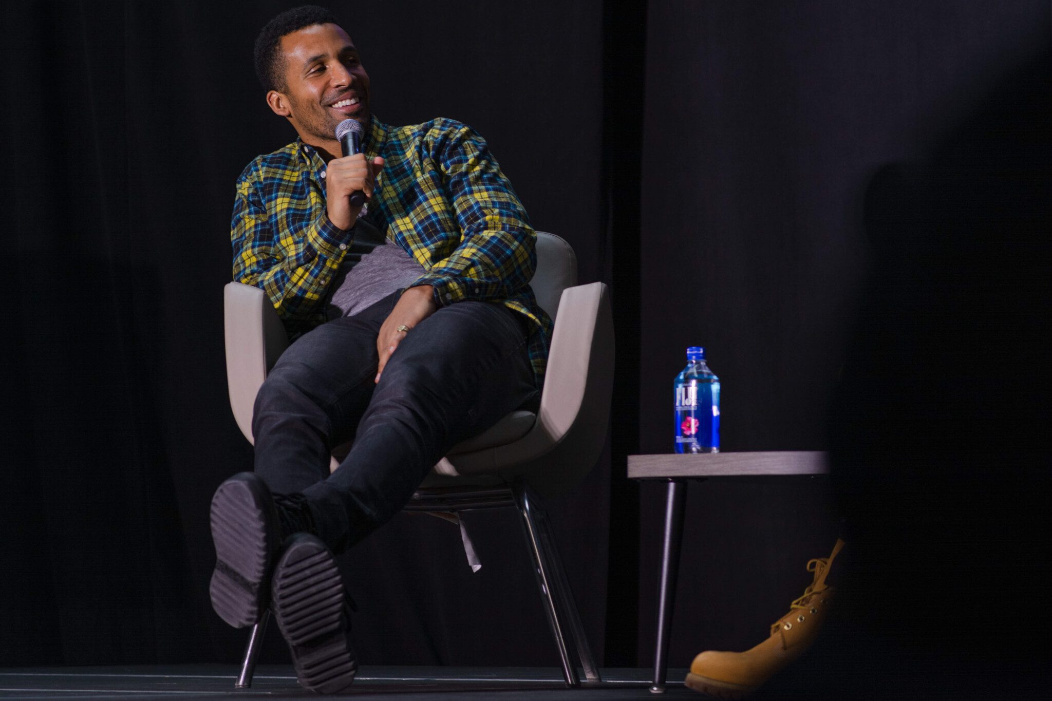 Matte Babel laughs on stage at Real Talks