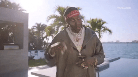 2 Chainz opening arms and digital fireworks coming out
