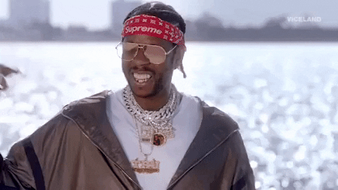 rapper 2 Chainz pointing to himself with smile on face