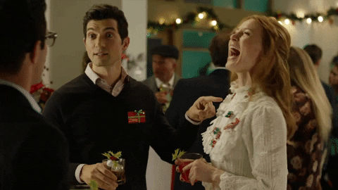 Man and woman cheering a drink.