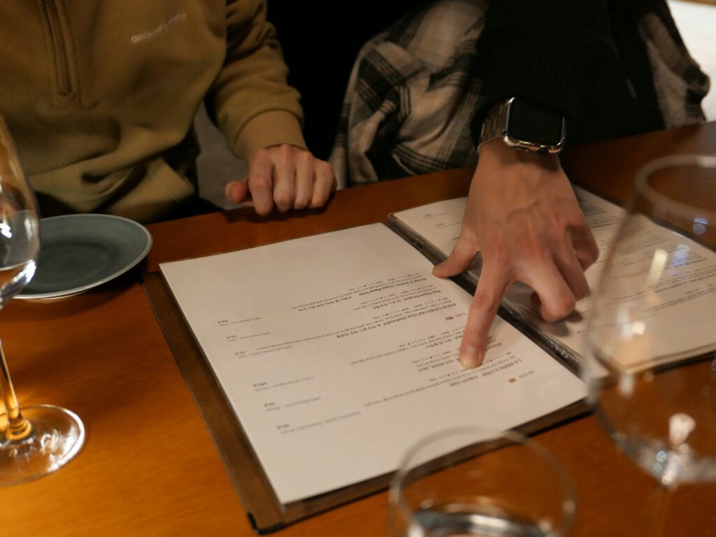 Hands pointing on a menu