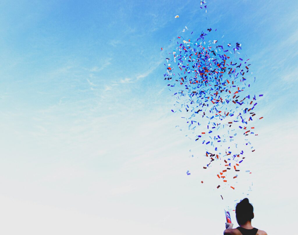 person bursting a surprise pop confetti
