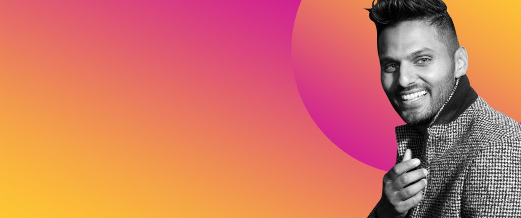 Jay Shetty smiling against pink and orange background.