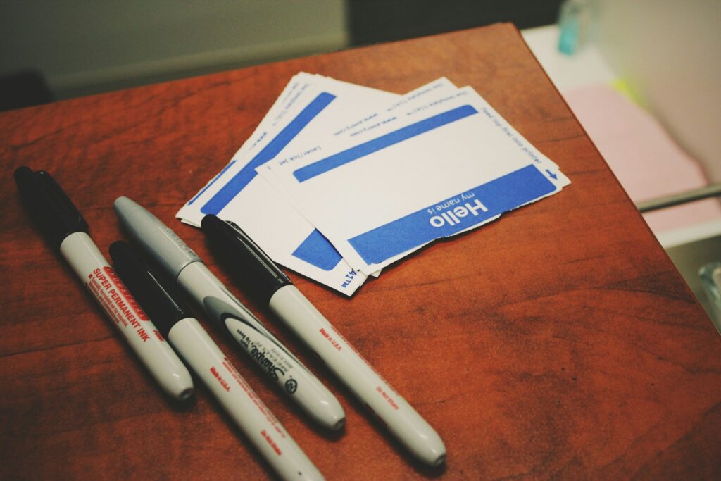 markers kept next to "hello my name is:" stickers