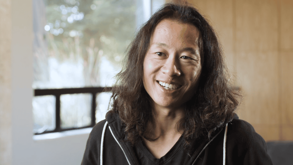 Justin Kan smiling during an interview.