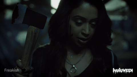 Koshy wielding an axe in a scene from Freakish.
