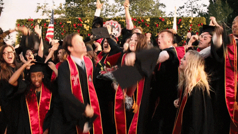 graduates tossing their cap in the air