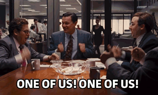 A group of men cheering with the caption "one of us, one of us!"