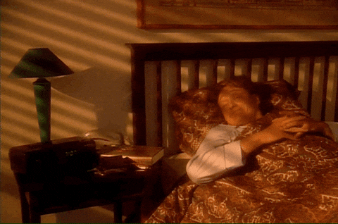 a man waking up early as the sun shines around his room