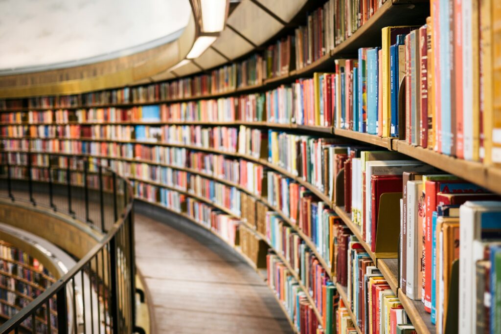 A long row of bookshelves stacked with books.