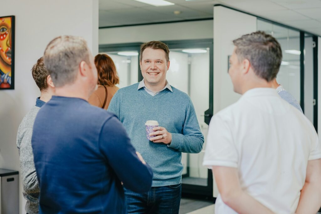 Coworkers standing and chatting 