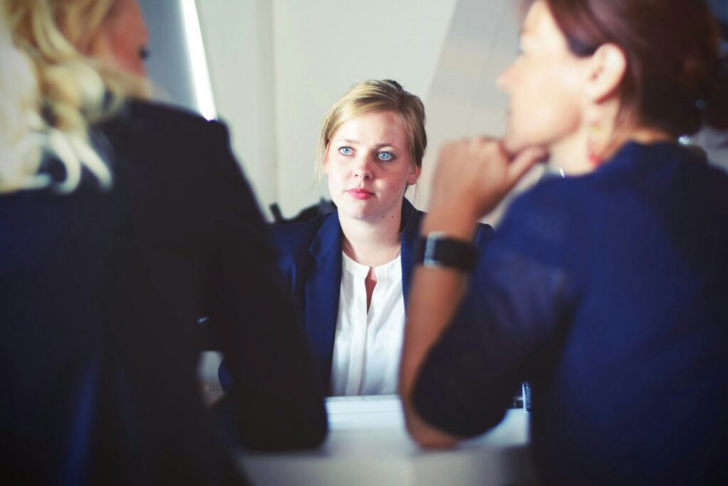 A woman interviewing two other candidates