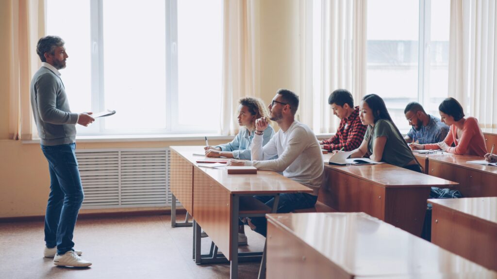 a classroom with students learning and a professor teaching