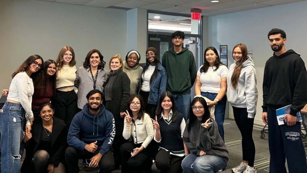 Jasleen Kaur posing with a large group of DBSA students.