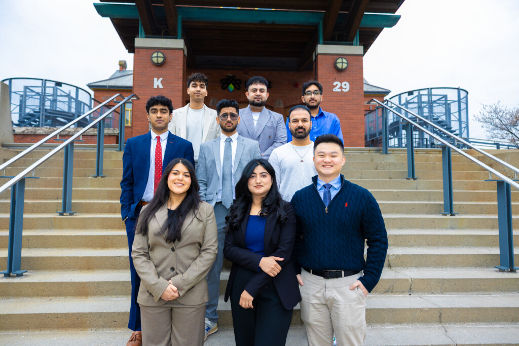 The IGNITE Board of Directors standing in front of the IGNITE K-Building at the Lakeshore campus.