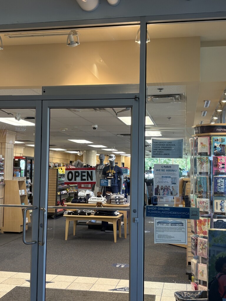 View through the glass door of the Lakeshore campus bookstore 