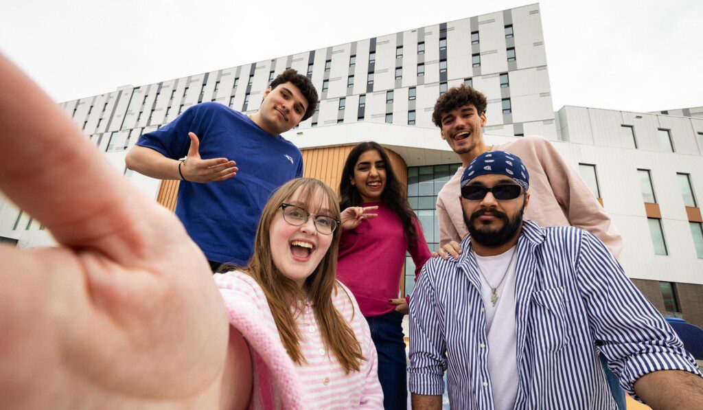 Photo of a friend group in front of the A- Building at Lakeshore campus