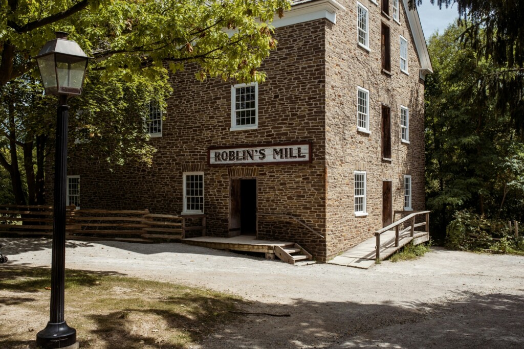 brick building at Black Creek Pioneer Village in Ontario, Canada. Sign above door reads "Roblin's Mill".